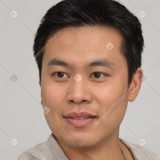 Joyful asian young-adult male with short  brown hair and brown eyes