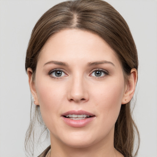 Joyful white young-adult female with medium  brown hair and grey eyes