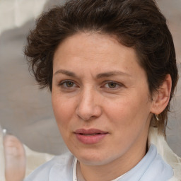 Joyful white adult female with short  brown hair and brown eyes