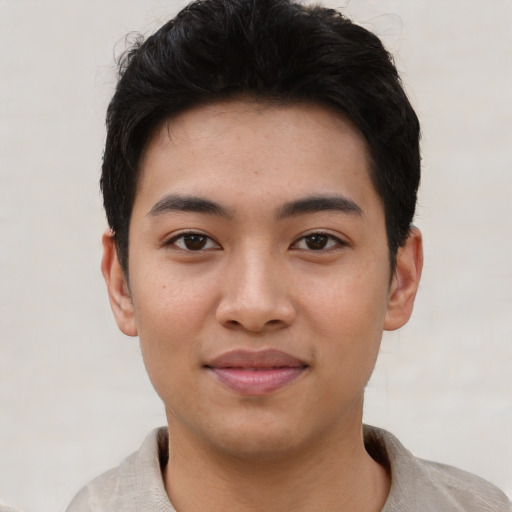 Joyful asian young-adult male with short  black hair and brown eyes