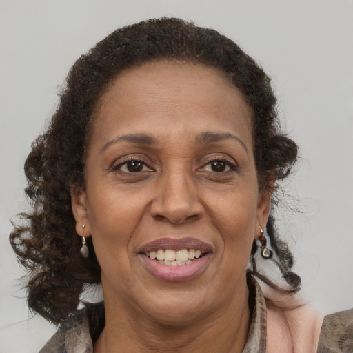 Joyful latino adult female with medium  brown hair and brown eyes