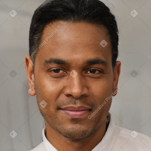 Joyful latino young-adult male with short  black hair and brown eyes