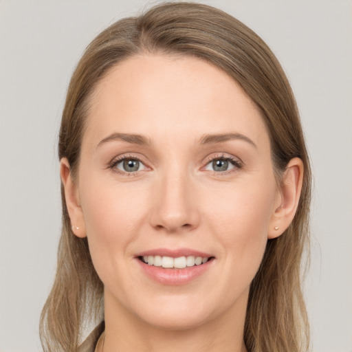 Joyful white young-adult female with long  brown hair and grey eyes