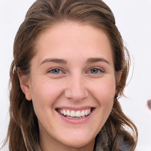 Joyful white young-adult female with long  brown hair and blue eyes