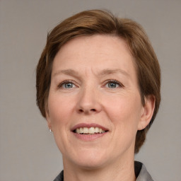 Joyful white adult female with medium  brown hair and grey eyes