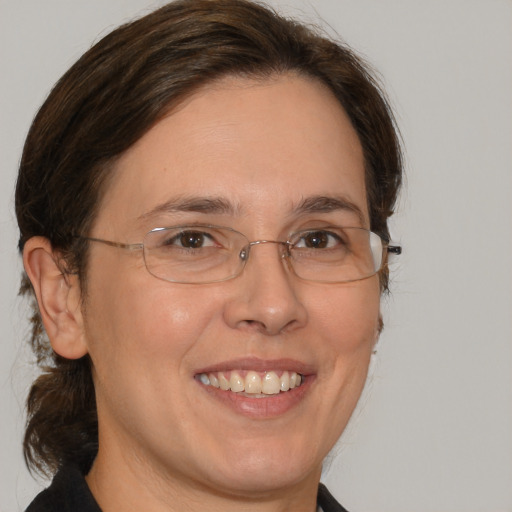 Joyful white adult female with medium  brown hair and brown eyes