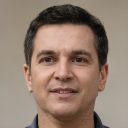 Joyful white adult male with short  brown hair and brown eyes