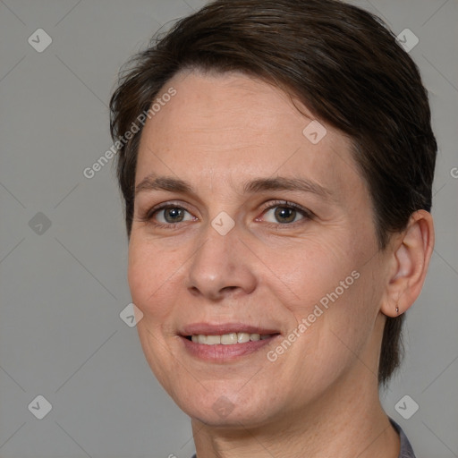 Joyful white adult female with medium  brown hair and brown eyes