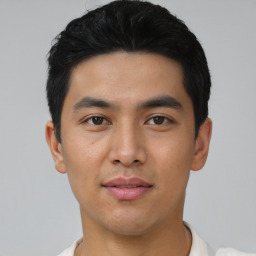 Joyful asian young-adult male with short  black hair and brown eyes