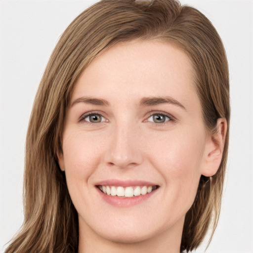 Joyful white young-adult female with long  brown hair and grey eyes