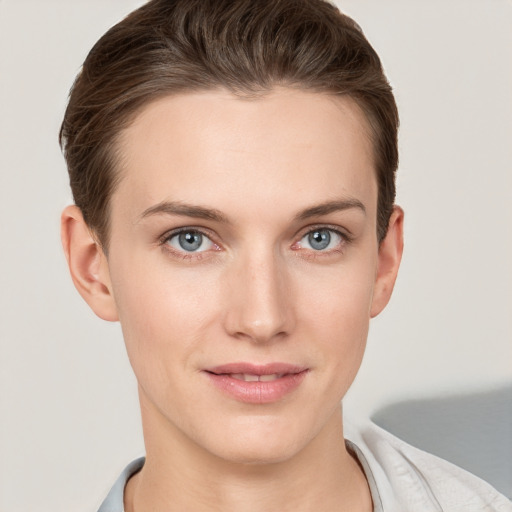 Joyful white young-adult female with short  brown hair and grey eyes