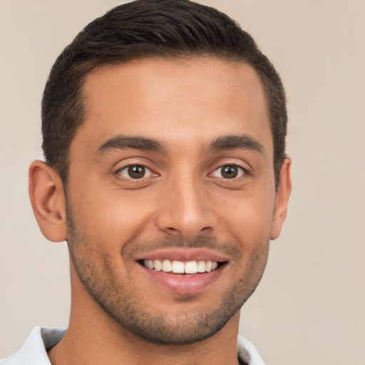 Joyful white young-adult male with short  brown hair and brown eyes