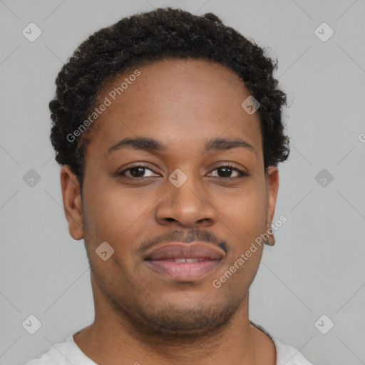 Joyful black young-adult male with short  brown hair and brown eyes