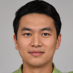 Joyful asian young-adult male with short  black hair and brown eyes