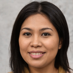 Joyful asian young-adult female with long  brown hair and brown eyes