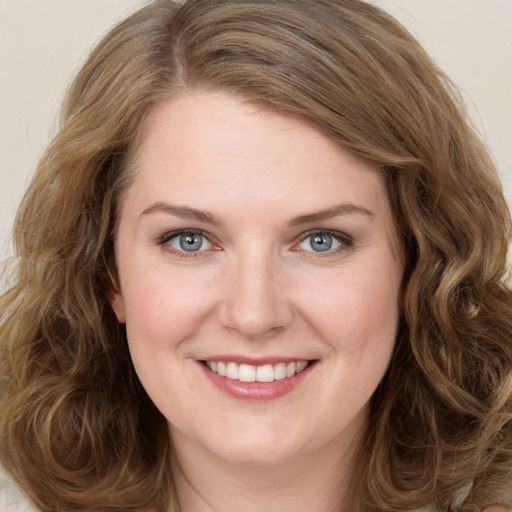 Joyful white young-adult female with long  brown hair and green eyes