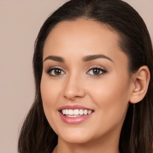 Joyful white young-adult female with long  brown hair and brown eyes