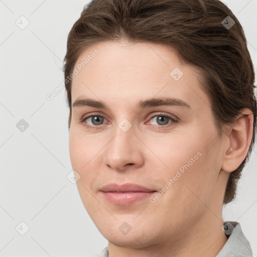 Joyful white young-adult female with short  brown hair and grey eyes