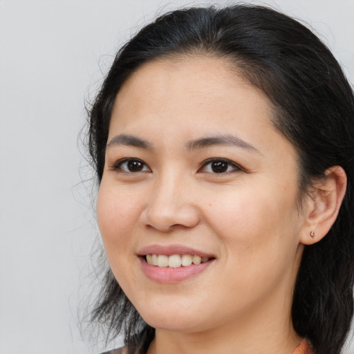 Joyful white young-adult female with long  black hair and brown eyes