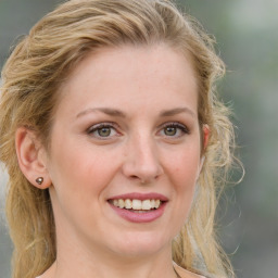 Joyful white young-adult female with medium  brown hair and green eyes