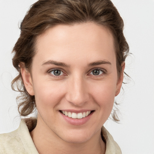 Joyful white young-adult female with medium  brown hair and blue eyes