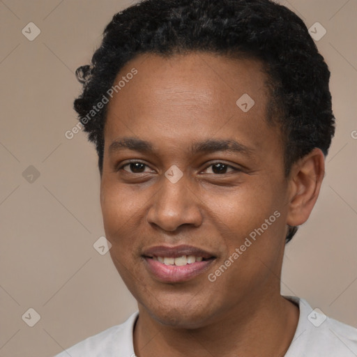 Joyful black young-adult male with short  black hair and brown eyes