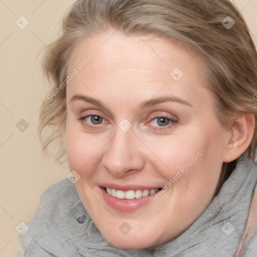 Joyful white adult female with medium  brown hair and blue eyes