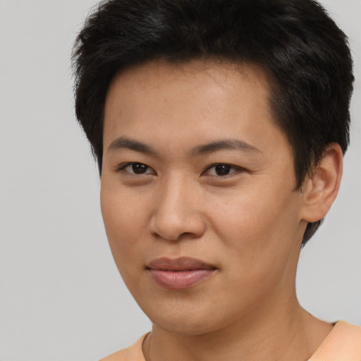 Joyful asian young-adult female with short  brown hair and brown eyes