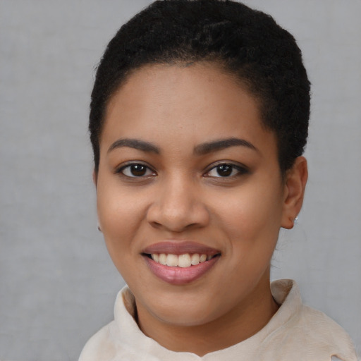 Joyful latino young-adult female with short  black hair and brown eyes