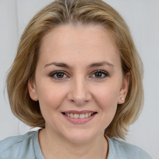 Joyful white young-adult female with medium  brown hair and blue eyes