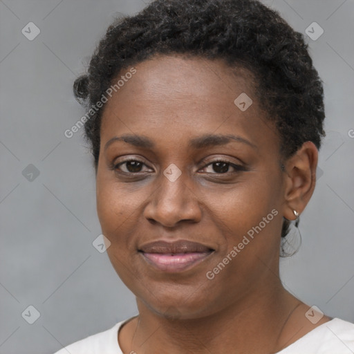 Joyful black young-adult female with short  brown hair and brown eyes