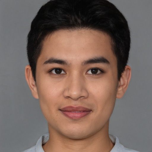 Joyful asian young-adult male with short  brown hair and brown eyes