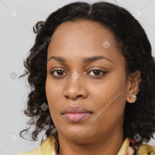 Joyful black young-adult female with long  brown hair and brown eyes