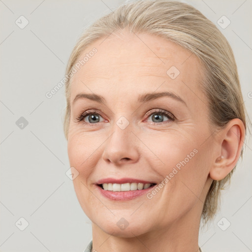 Joyful white adult female with medium  brown hair and blue eyes