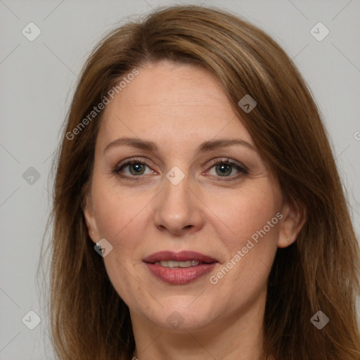 Joyful white adult female with long  brown hair and grey eyes