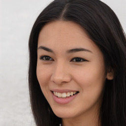 Joyful asian young-adult female with long  brown hair and brown eyes