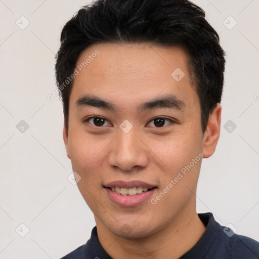 Joyful asian young-adult male with short  black hair and brown eyes