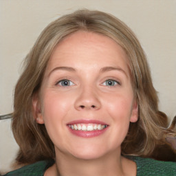 Joyful white young-adult female with medium  brown hair and green eyes