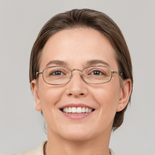 Joyful white young-adult female with short  brown hair and grey eyes