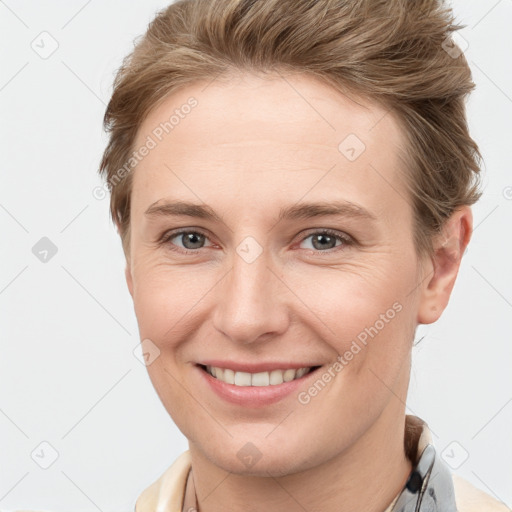 Joyful white young-adult female with short  brown hair and grey eyes