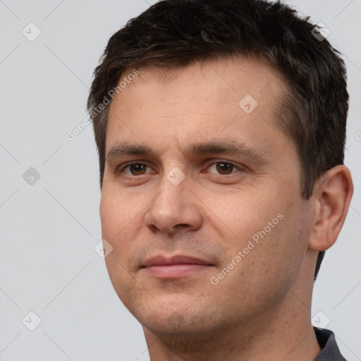 Joyful white adult male with short  brown hair and brown eyes