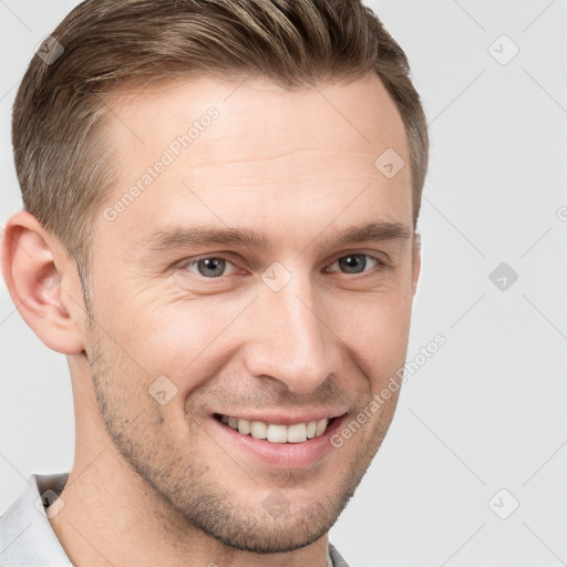 Joyful white young-adult male with short  brown hair and grey eyes