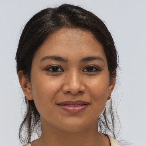 Joyful latino young-adult female with medium  brown hair and brown eyes