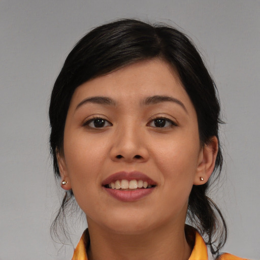 Joyful asian young-adult female with medium  brown hair and brown eyes