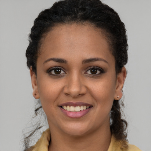 Joyful latino young-adult female with short  brown hair and brown eyes