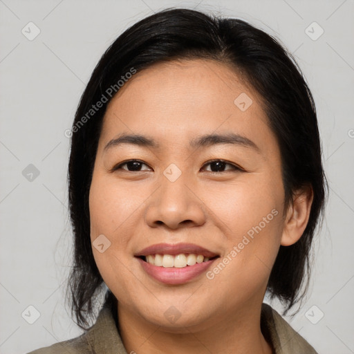 Joyful asian young-adult female with medium  black hair and brown eyes