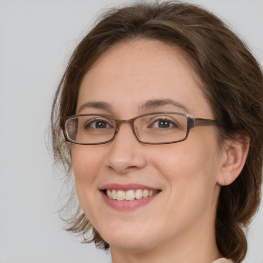 Joyful white adult female with medium  brown hair and brown eyes