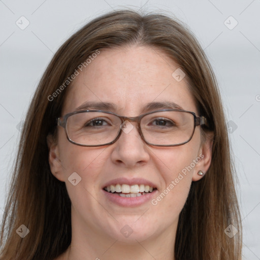 Joyful white adult female with long  brown hair and blue eyes