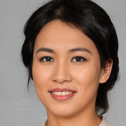 Joyful asian young-adult female with medium  brown hair and brown eyes