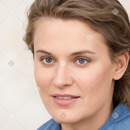 Joyful white young-adult female with medium  brown hair and blue eyes